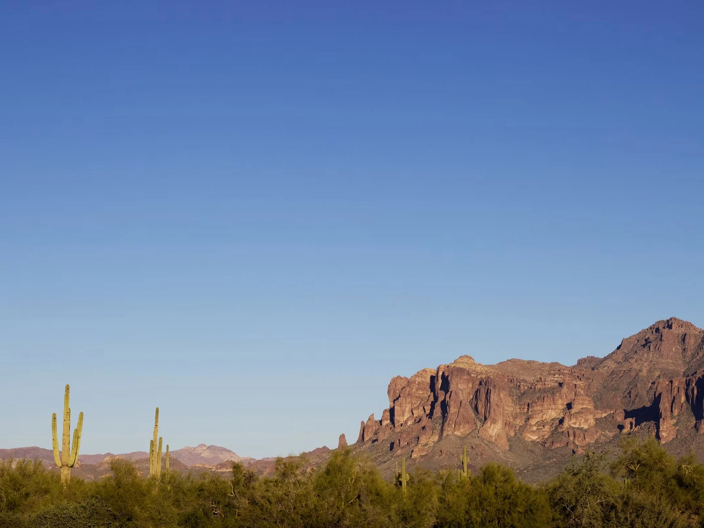 A calm, clear desert horizon with mountains near Apache Junction, Arizona.